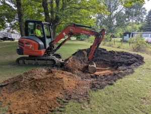 Excavator digging area for septic field.
