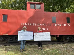 Donation checks from Cherryland Electric Co-Op and CoBank.