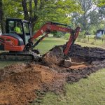 Excavator digging area for septic field.